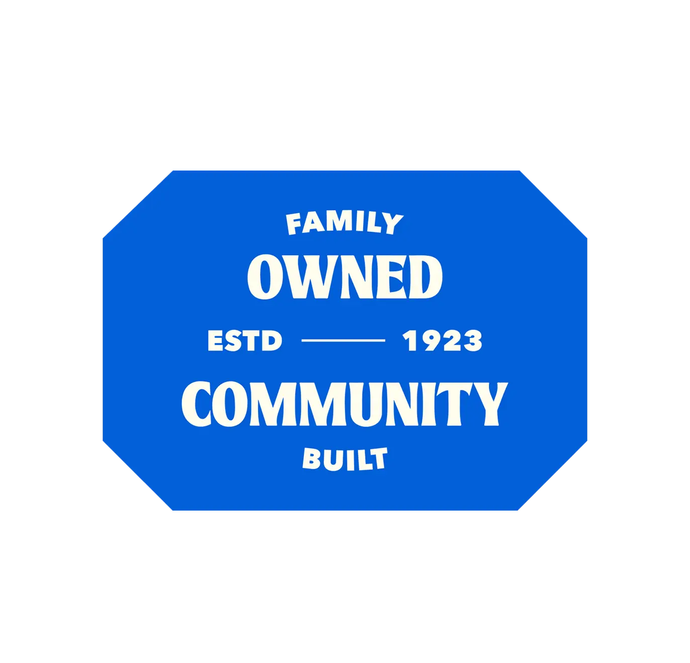A solid blue octagonal badge on a black background featuring bold white text that reads: "FAMILY OWNED" at the top, "ESTD 1923" in the center, and "COMMUNITY BUILT" at the bottom.